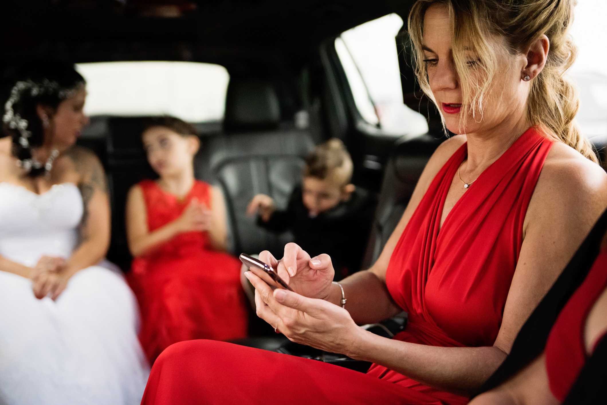 Bridal party riding in limousine in New Jersey heading to wedding venue